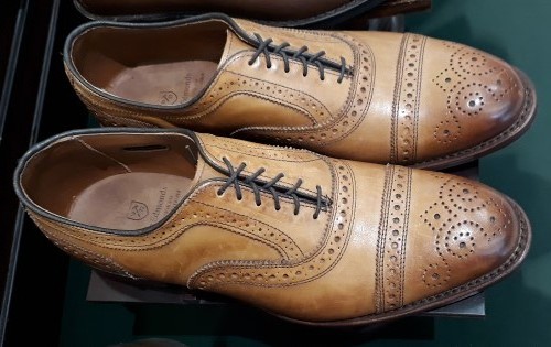 In leather of the walnut hue, here's a pair of Allen Edmonds Strands Wingtip Oxford men's shoes.