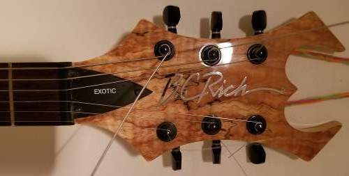 The headstock of an awesome B.C Rich Warlock Exotic Model electric guitar with wood of natural spalted maple.