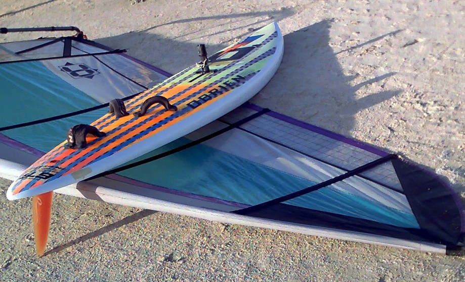Mike Kimbro's Aerotech 7.5 sail behind his vintage 1989 O'Brien Epoxy Lite 9.9 windsurfer, complete with Rainbow fin and Streamlined universal.