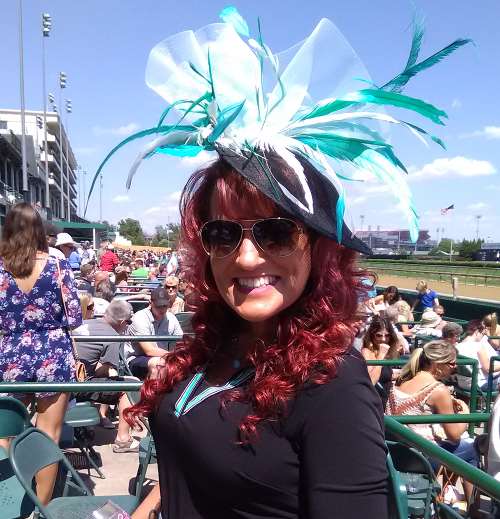 Here's a pic of lovely redhead with a fascinator in the stands at Chruchill Downs in Louisville, but NOT at either the Kentucky Derby or the Kentucky Oaks horse races.