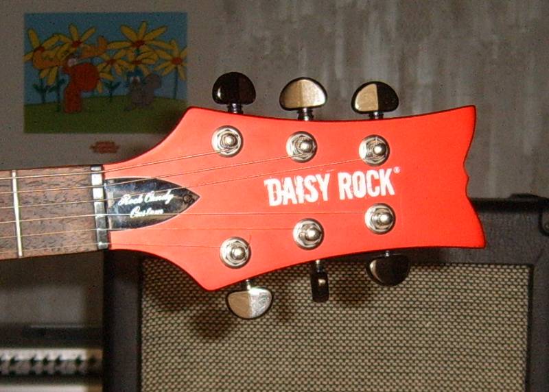 The head stock of the Daisy Rock guitar, model Rock Candy Custom Aztec Goddess