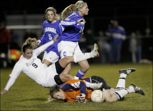 Photo Credit: by Joe Vitti of The Indianapolis Star, "Carmel goalkeeper Emma Gormley is run over by Noblesville's Mary Kreger (9), with Carmel players Kate Hanni (5) and Jessica Rix (14) nearby."