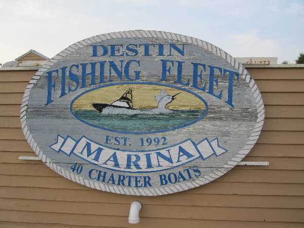 Photograph of the Destin Fishing Fleet sign at the marina by the Emerald Grande at Harborwalk Village.