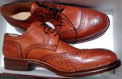 In orange, men's shoes by Bergdorf Goodman found at Neiman Marcus Last Call in Grapevine.