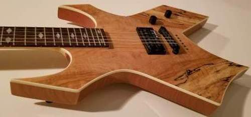 Natural spalted maple body B.C. Rich Warlock Exotic Edition electric guitar with single Rockfield humbucker pickup and T.O.M bridge and string through body.