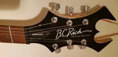 Widows head stock of a basic black Warlock Special Edition electric guitar by BC Rich Guitars with a rosewood fingerboard.