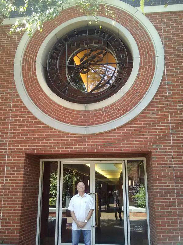 Taken during one of my regular trips to Tennessee, here is a photo of the author standing at the entrance of the office of financial aid at Vanderbilt University. I chose this building because it was close to the road, and because the English Department seems to all be in the Science Building, which some how messed with the vibe, or so it seemed on that lovely September day.