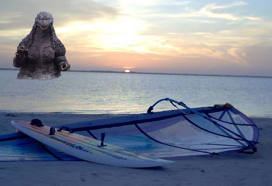 A sunset view of Godzilla approaching Chrome Dome Mike's windsurfing rig on the beach at the Bird Island Basin by the Worldwinds Windsurfing concession located just south of Corpus Christi, Texas, by the Lagua Madre.