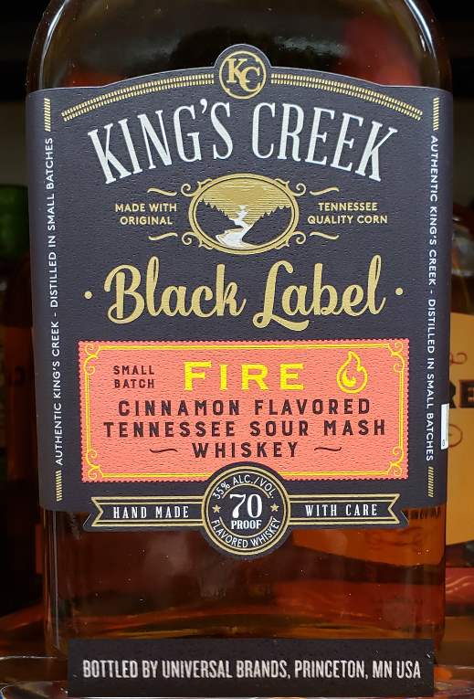 A 750ml bottle of King's Creek Black Label Fire Cinnamon Flavored Tennessee Sour Mash Whiskey produced by the Universal Brands Company of Princeton, MN.