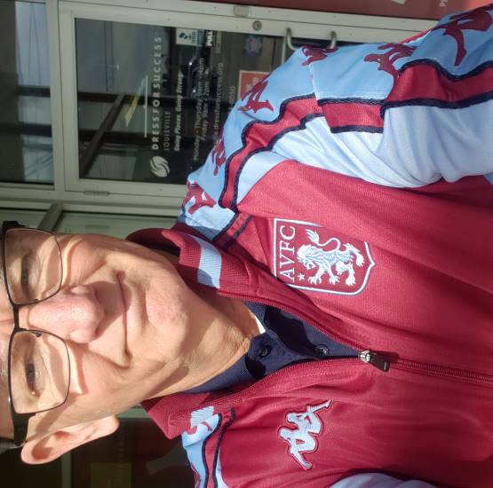 Here's Chrome Dome Mike Kimbro in a track jacket from England's Aston Villa FC.