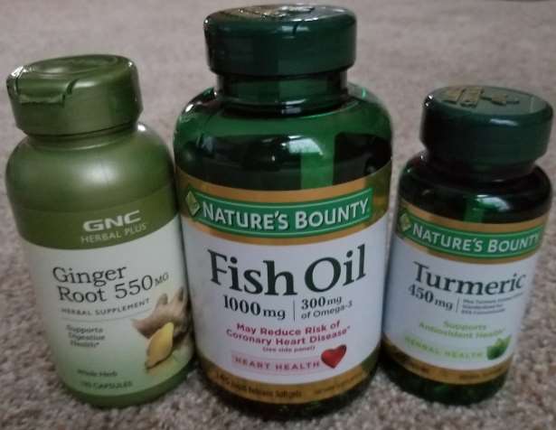 A photo of bottles of the capsule form of the health supplements Ginger, Fish Oil, and Turmeric, all 3 of which are thought to treat inflammation, which is present when coronavirus attacks the lungs of COVID-19 patients.