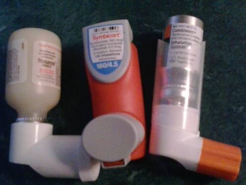 Three different inhalers for asthma and COPD, Primatene Mist, Symbicort, and Combivent Respimat.