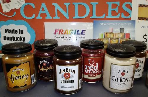An assortment of candles with fragrances of various Jim Beam brand bourbons and liquors, including Honey, Maple, and Ghost.