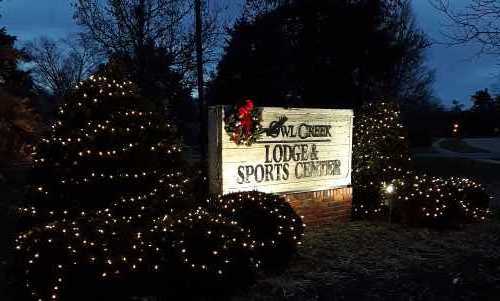 Pic of the sign on an evening during December of 2018 in from of the Owl Creek Lodge and Sports Center in Louisville, Kentucky, with full Christmas regalia.