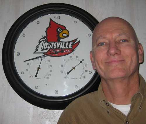 Kentucky poet and former student of the Speed Scientific School of the University of Louisville, and big time U of L fan Chrome Dome Mike Kimbro posing with his stylish Louisville Cardinals clock.  Unfortunately, the damn thing crapped out after just 3 months.  And yes, I did try changing the battery.