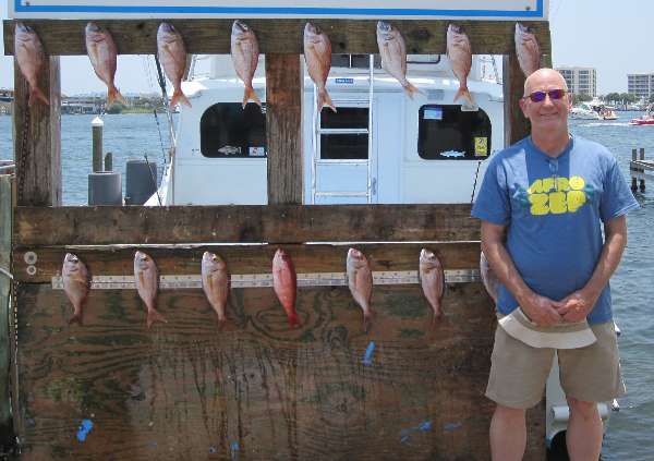 Rocking an awesome t-shirt by the AfroZep band, Chrome Dome Mike posing with the white and mingo snappers caught out on the Gulf of Mexico just south of Destin, Florida.
