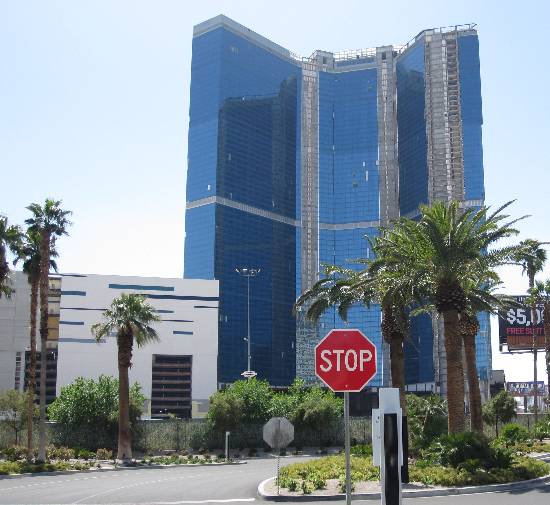 Pic of the STOP sign on the south side of the SLS Resort in Las Vegas, featuring a backdrop of the palm trees in front of the Fontainebleau building on Las Vegas Boulevard.