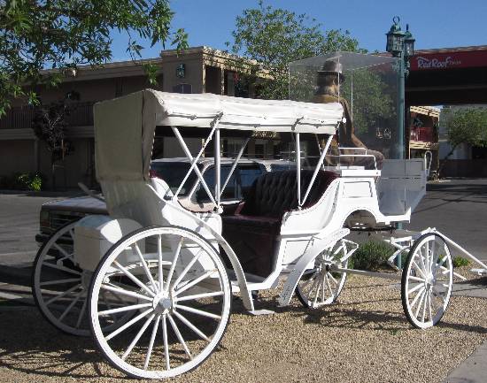 Photo of the white carriage parked in front of The Red Roof Inn on Paradise Road in Las Vegas, Nevada.