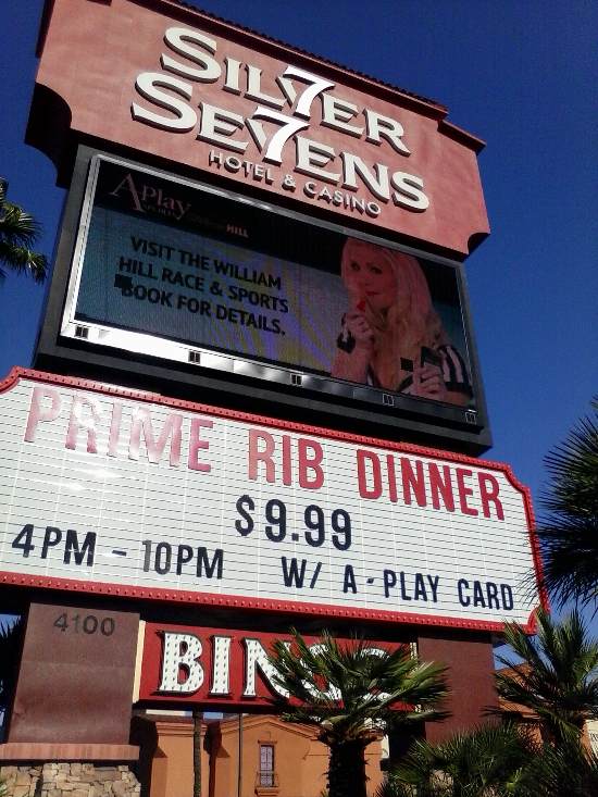 Pic of the outside of the Siver Sevens Hotel and Casino in Las Vegas, featuring their $9.99 prime rib dinner, with A-Play card.