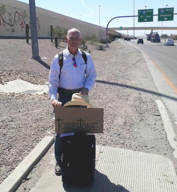 Chrome Dome Mike hitchhiking in Tucson, AZ on the onramp to I-10 and I-19 which lead to El Pase and Nogales respectively.