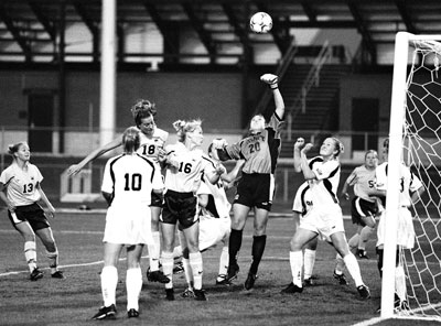 Photo by Travis Mathews, staff photographer for www.themaneater.com on September 14, 2001.  Displayed with the caption: Drury goalkeeper Britt, flanked by a host of Missouri players, punches the ball away...